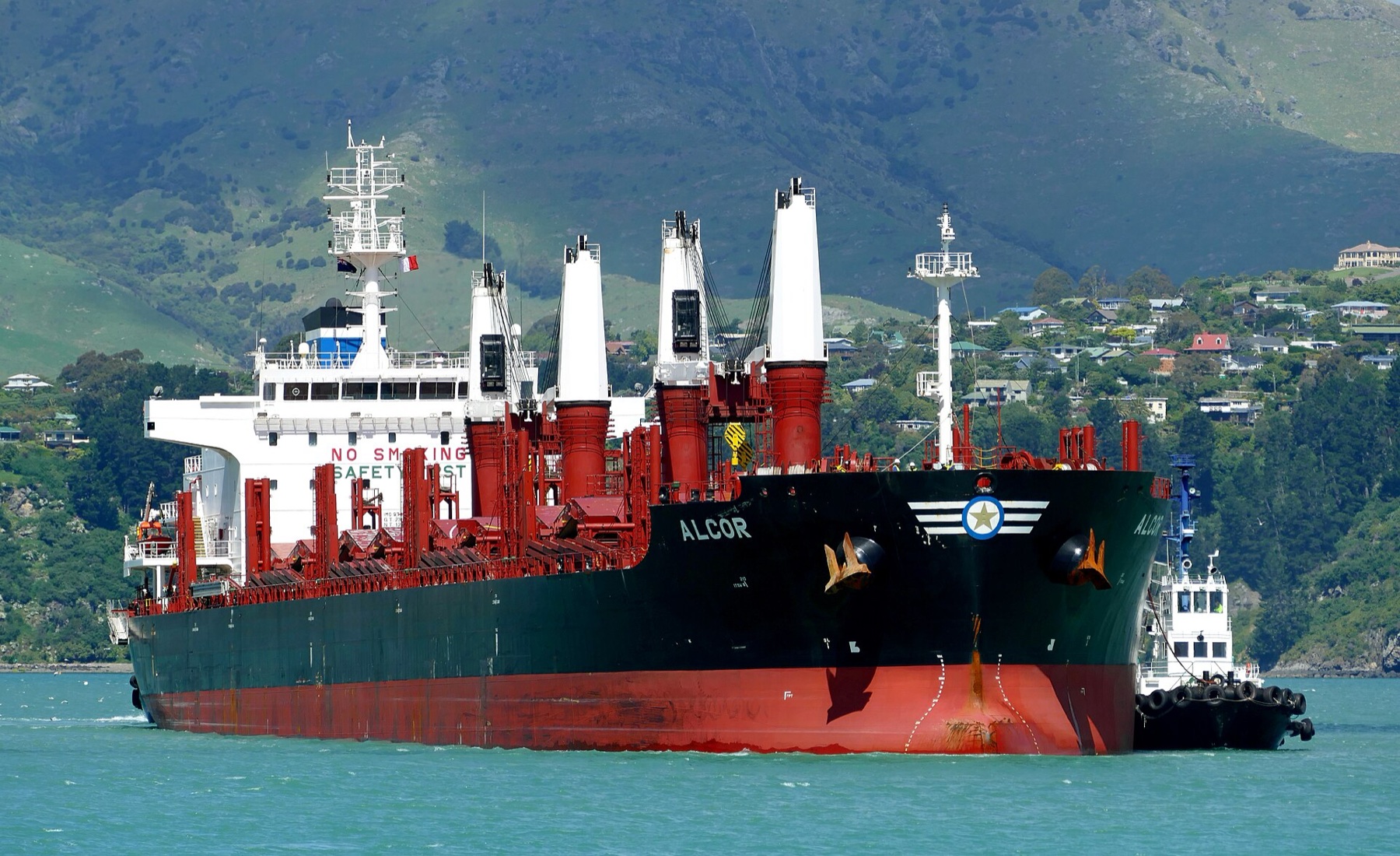 Bulk carrier under tug escort approaching port
